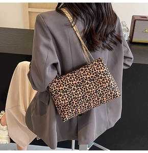 Chic leopard print chain bag shown on model with grey blazer for everyday style