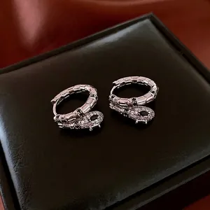 Elegant silver snake hoop earrings with pavé zircon stones and detailed scale texture