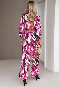 Detailed back view of pink and black abstract print two-piece set with long pants