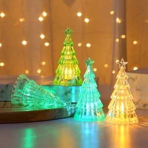 Macro detail of glowing crystal Christmas tree night lights with LED star toppers