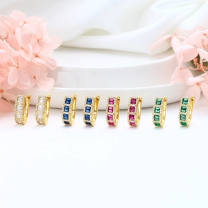 Set of four S925 silver hoop earrings with colorful square zircons on a white silk display