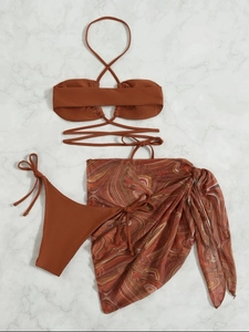 Detailed flat lay of three-piece bikini set with caramel top and marble mesh sarong
