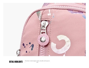 Detailed macro view of pink nylon bag featuring a fancy star engraved metal zipper head