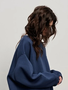 Detailed side view of navy crewneck sweatshirt showing dropped shoulder and premium fabric