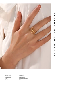 Detail of 18K gold-plated stainless steel layered rings on a fashion model hand