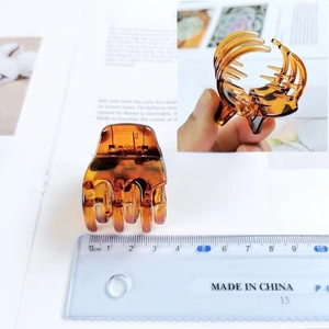 Detailed view of a 3.5cm amber resin square hair claw clip next to a measuring ruler