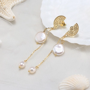 Detail of S925 silver pearl drop earrings with fan-shaped motif and layered chain