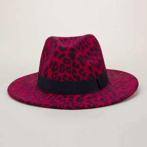 Detail of red leopard print wool fedora with black decorative ribbon and wide brim