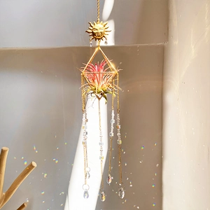 Golden sun suncatcher with crystal prisms creating rainbow reflections on walls