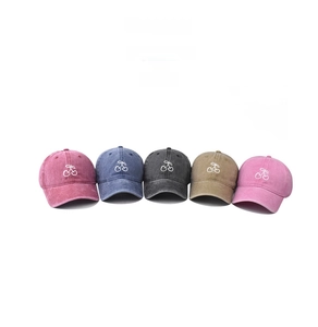 Detail showing five colors of washed cotton baseball caps with cherry embroidery