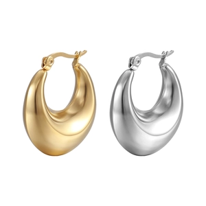 Detailed view of polished gold and silver teardrop hoop earrings on white background