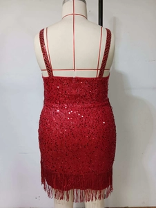 Detail of red sequined dress showing back view with shimmering fringe on the hem