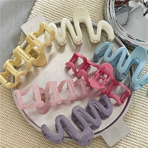 Colorful wave-shaped plastic hair claws set in six assorted pastel and vibrant colors