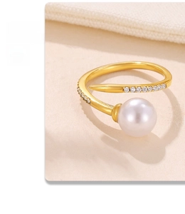 Macro shot of gold adjustable ring with white pearl and micro-pave cubic zirconia accents