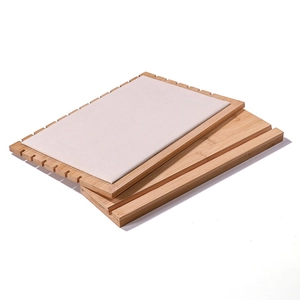 Bamboo necklace display stand with beige velvet surface for jewelry presentation