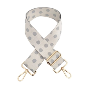 Close-up of adjustable bag strap with grey polka dots and golden metal lobster clasps