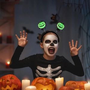 Glowing LED Halloween pumpkin headband with green spring-loaded eyes for party costume