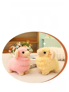 Detailed close-up of fluffy pink and yellow plush sheep toy with spiral horns and soft fur