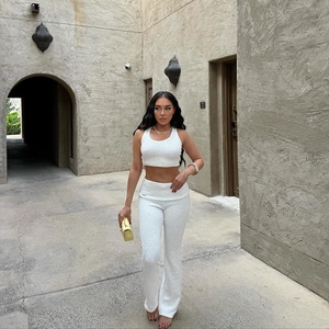 Detailed texture of white textured knit two-piece set featuring vest and wide-leg pants