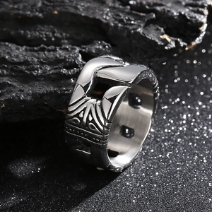 Punk silver stainless steel hollow engraved ring set on a dark textured background