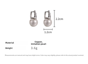 Detailed view of luxury white pearl earrings with cubic zirconia inlay in copper setting