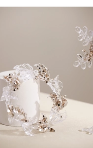 Detail of transparent acrylic Christmas ornaments with gold and silver glitter flakes