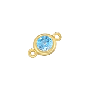Macro shot of gold double-loop connector with light blue gemstone for DIY jewelry making