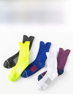 Detail showing various colors of professional non-slip basketball socks with ribbed cuffs