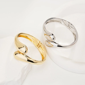 Elegant gold and silver teardrop open bangles with high-polished metallic finish