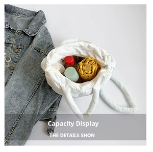 Spacious interior of white quilted puffer tote bag showing umbrella and water bottle storage