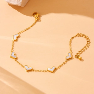 Gold stainless steel heart bracelet with white shell inlays and adjustable chain links