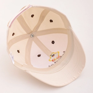 Detail of baby baseball cap interior showing embroidered cartoon and quality stitching