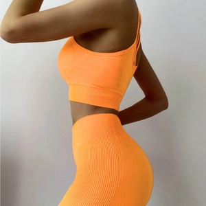 Seamless bright orange yoga set with sports bra and high-waisted leggings for fitness