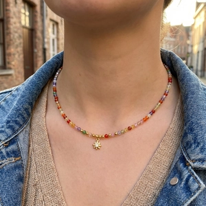 Bohemian colorful gemstone beaded necklace with golden sun pendant on model