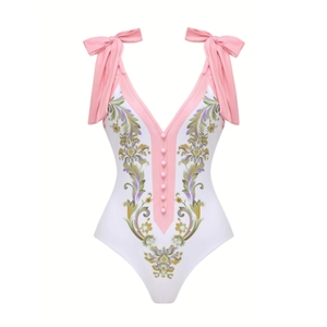 Detail of V-neck one-piece swimsuit with floral print, pink bows, and buttons