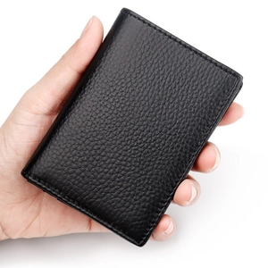 Genuine black leather business card holder with lychee grain texture shown in hand