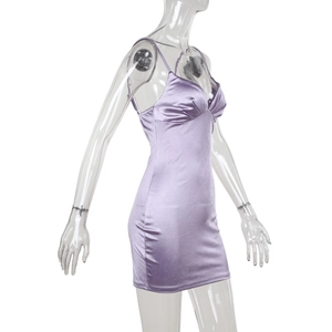 Detail of purple satin mini dress showing v-neck twist design and glossy fabric texture