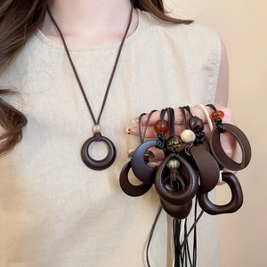 Detail of vintage geometric resin pendants on wax cord necklaces with amber bead accents