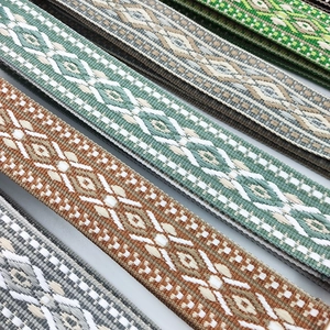 Close-up of jacquard woven geometric straps for bags and cameras in various vintage patterns
