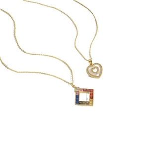 Gold LOVE pendant necklace with heart and multicolor crystal set on white background