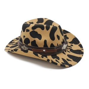 Cow print felt cowboy hat with leather band and vintage silver metal buckle on white background