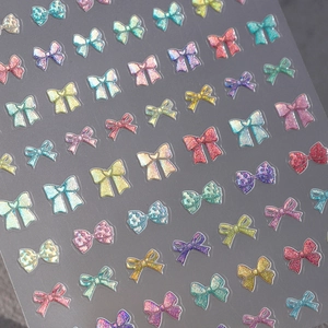 Colorful glitter bow nail stickers with 3D laser gold effect in vibrant multi-color set