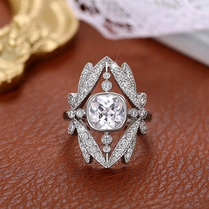Luxurious silver crown ring with cushion-cut centerpiece and pavé diamonds on leather