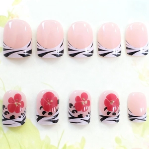 Short square press-on nails with pink base, zebra stripes and red floral accents