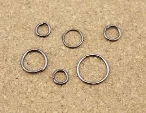 Detailed macro shot of assorted gunmetal jump rings for DIY jewelry making