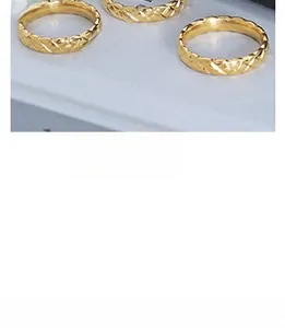 Macro shot of 18K gold plated titanium steel rings with quilted diamond pattern