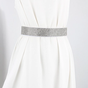 Detailed view of shimmering silver rhinestones on elastic white waistband