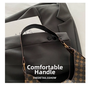 Close-up of the comfortable handle and vintage pattern on this crescent shoulder bag