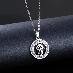 Close-up of circular Hamsa pendant with sparkling rhinestones on a stainless steel chain