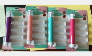 Manual cake airbrush set with four colorful pumps and interchangeable nozzles in blister pack
